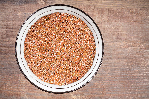 istock Linseed in bowl on wooden background 510855946