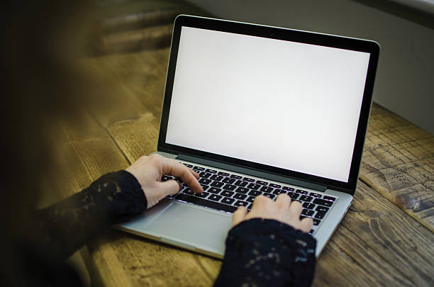 istock Typing at a laptop with blank screen 510856788