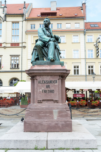 Wroclaw, Poland - August 3, 2014: Monument comedy-writer Aleksander Fredro made of bronze in year 1897 by sculptor Leonard Marconi in Wroclaw.