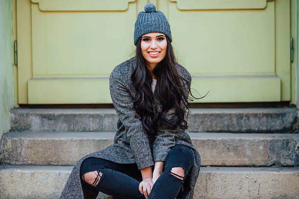 istock Girl posing sitting on a bench in the city streets 510857230