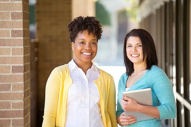 Photo of Business women standing outside an office building.