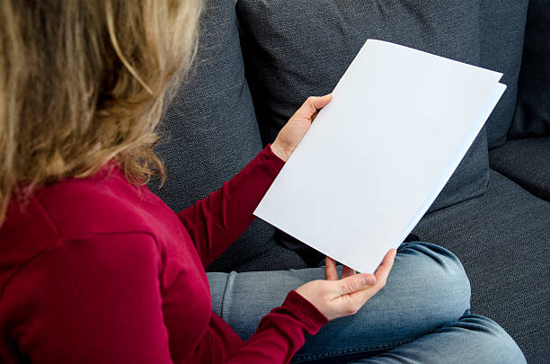 istock Woman looking at a blank magazine 510857718