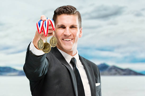 istock Smiling businessman holding medal 510858644