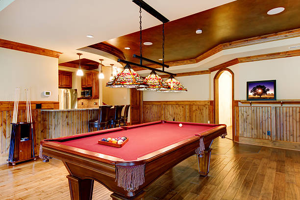 istock Large hardwood floor room with pool table and bar. 510859346
