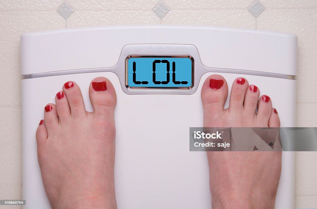 Scale with Feet LOL Digital Bathroom Scale Displaying LOL text Weight Scale Stock Photo