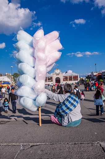 Toluca, Mexico - December 26, 2015: An old saleswoman selling cotton candy in the Toluca downtown, place known as 