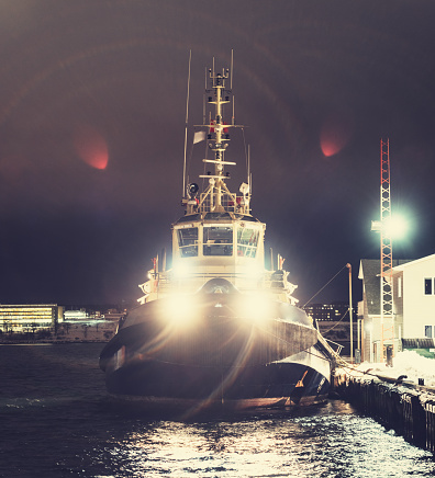 A tugboat moored on the Halifax waterfront at night.  Long exposure.