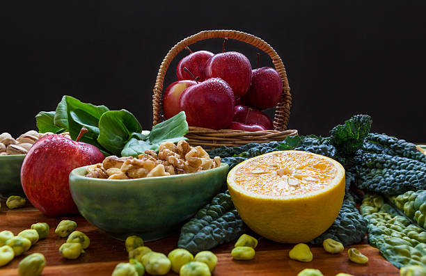 fruits, nuts, and greens on black