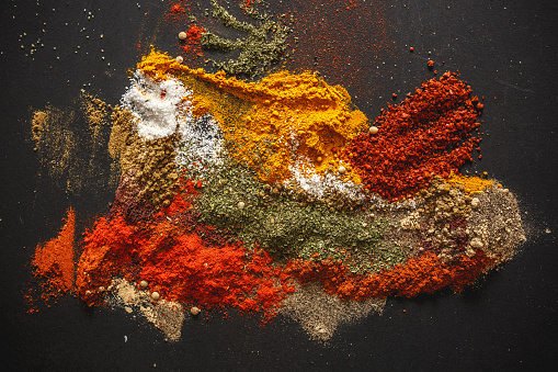 Various kinds of spices on black background.
