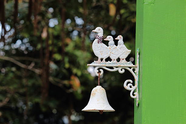 White Ducks Doorbell Hanging On Green Pillar