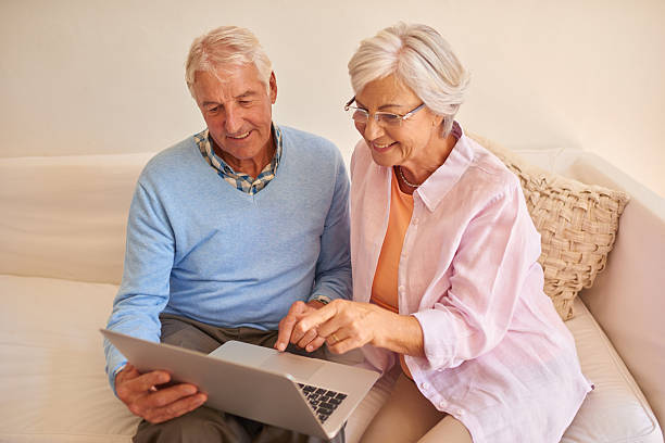 istock Senior couple using laptop together at home 510866062