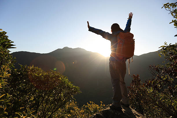 istock successful woman hiker open arms on sunrise mountain peak 510867912