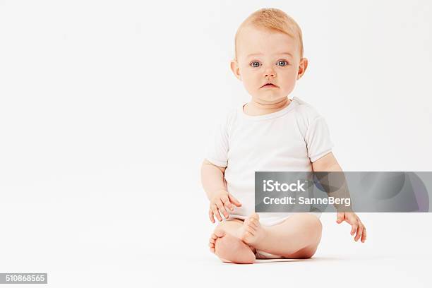 Portrait Of Young Baby Girl Studio Stock Photo - Download Image Now - Baby - Human Age, Displeased, Infant Bodysuit