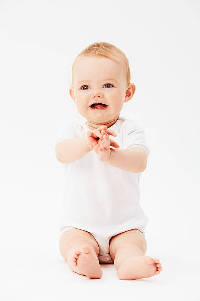 istock Young baby girl with clasped hands, studio 510869243