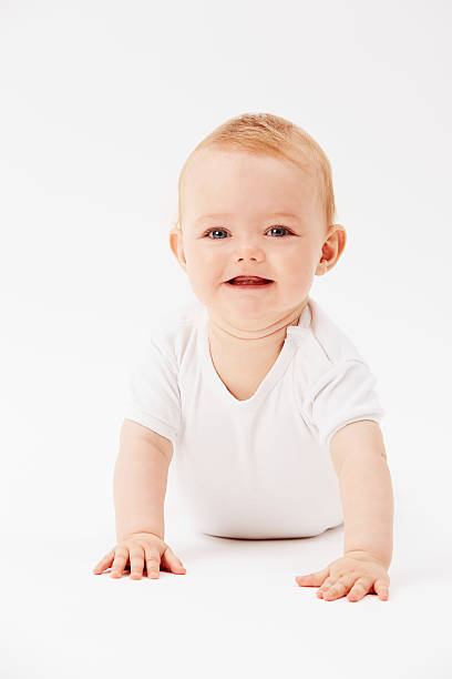 istock Young baby girl crawling on front, studio 510869247