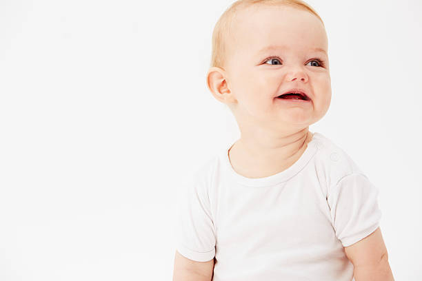 istock Young baby girl looking away, studio 510869257
