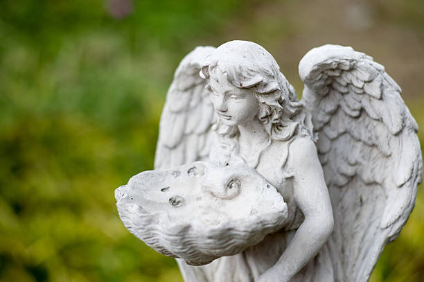 istock Angel statue in nature place in soft light 510869630