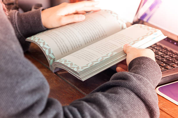 istock Woman reading book on work station 510869696