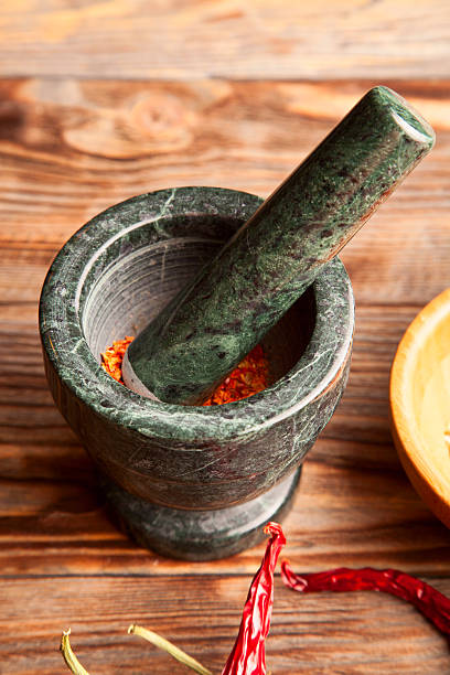 istock Stone mortar and green chili peppers 510871098