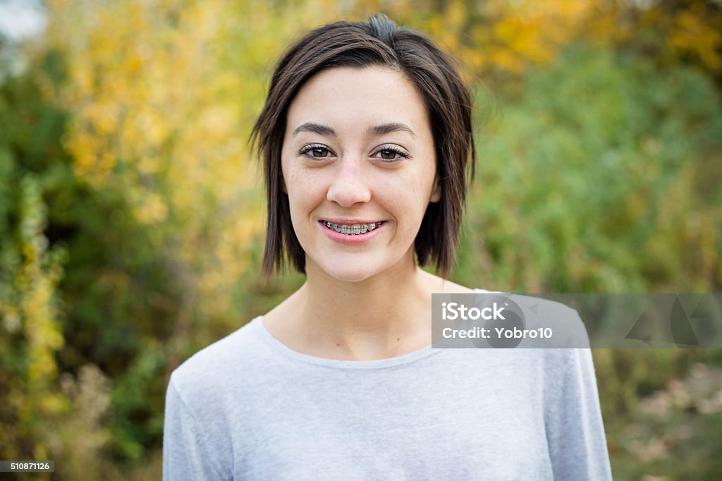 Beautiful Hispanic Teen Girl portrait with braces A beautiful Hispanic teen girl outdoor portrait. Cute and smiling with a mouth full of braces 16-17 Years Stock Photo