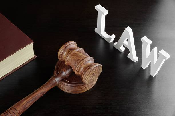 istock Judges Gavel, Red Book And Sign LAW On Black Table 510872102
