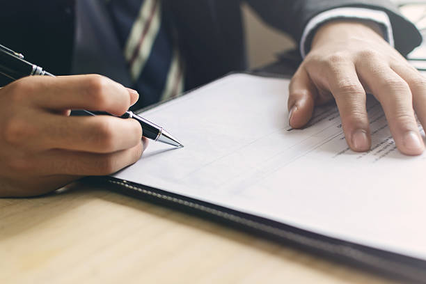 istock Human Hand Signing on Formal Paper at the workplace 510872444