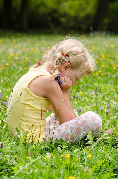 istock blond girl on grass 510873373