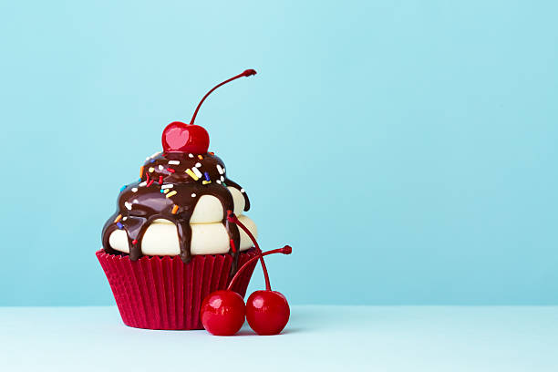 Ice cream sundae cupcake Ice cream sundae cupcake with copy space to side cherry photos stock pictures, royalty-free photos & images