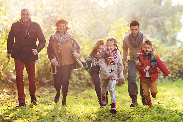 istock Happy multi-generation family having fun in the park while chasing. 510873536