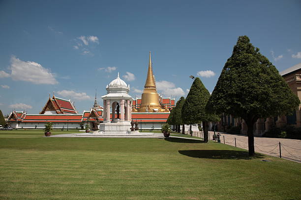 Bangkok, Thailand - July 17, 2024: View of a stupa surrounded by lush temple gardens in the vicinity of Wat Arun, highlighting the rich cultural and spiritual environment of old Bangkok.