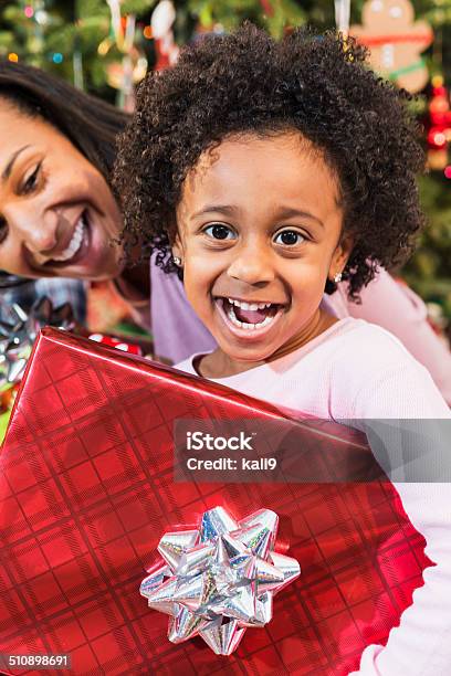 Little African American Girl Holding Christmas Present Stock Photo - Download Image Now