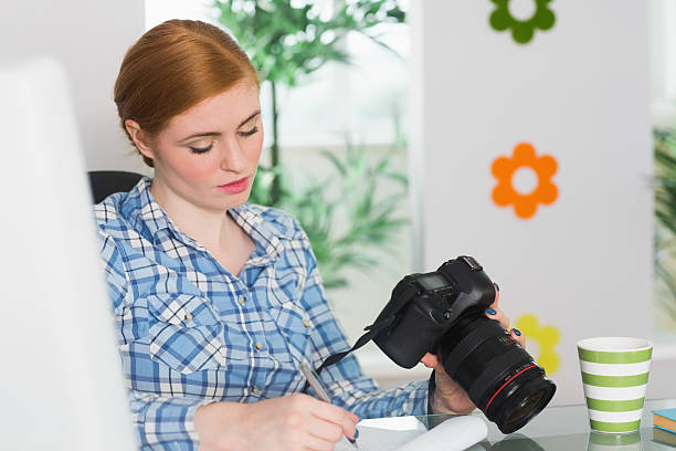 istock Focused photographer sitting at her desk 510898831