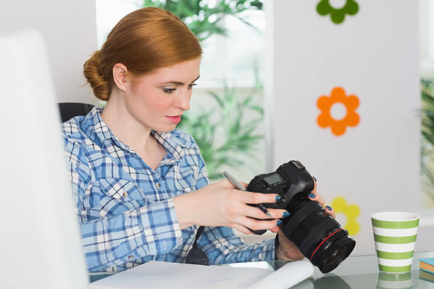 istock Focused photographer sitting at her desk 510898833