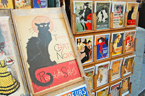 Paris, France - October 31, 2012: the famous poster of Le Chat Noir, the black cat, and other french cards for sale in Montmartre, Paris. Le Chat Noir was a famous cabaret club in the 19th century in Montmartre.