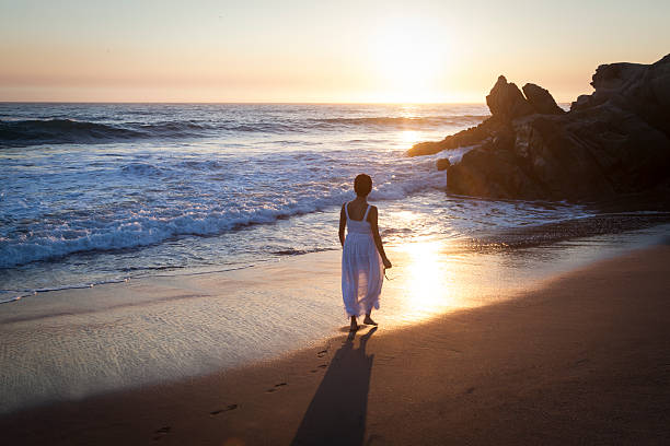 istock Woman walking on beach 510899051