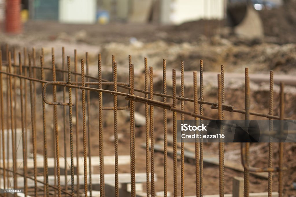 Construction SIte Ground Work Steel Frame Steel rods set in concrete on a construction site forming part of the building foundation - wide view of construction site with foundation framework in place Blue-collar Worker Stock Photo