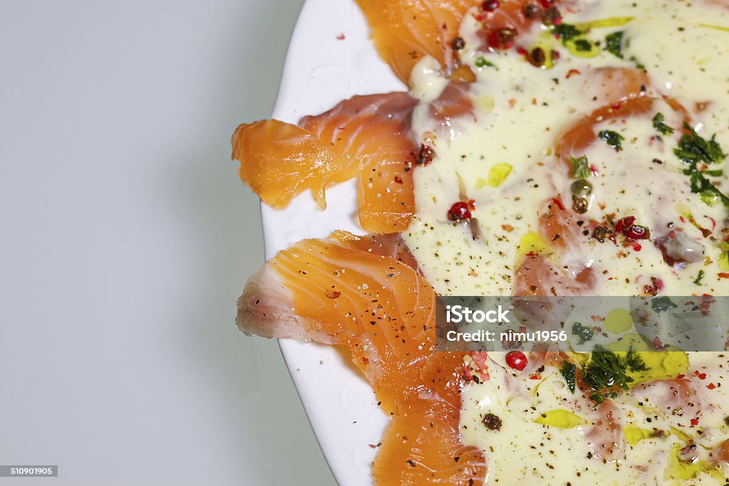 Marinated salmon Marinated salmon with a lemon sauce and fresh parsley Appetizer Stock Photo