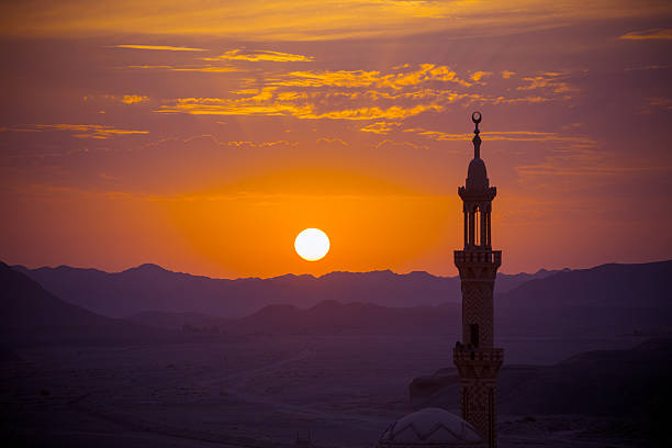 Sunset over desert with muslim mosque in the foreground stock photo