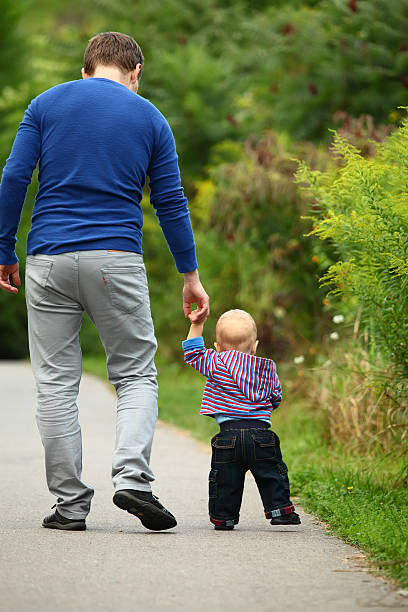istock Father walking with a baby boy 510902657