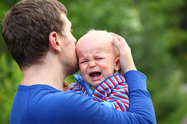 istock Father consoling crying baby boy 510903253