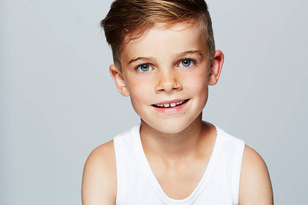 istock Portrait of young boy in vest, studio 510903753