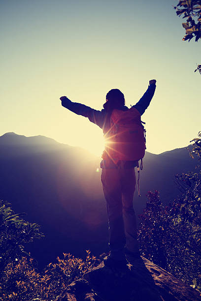 istock successful woman hiker open arms on sunrise mountain peak 510923448