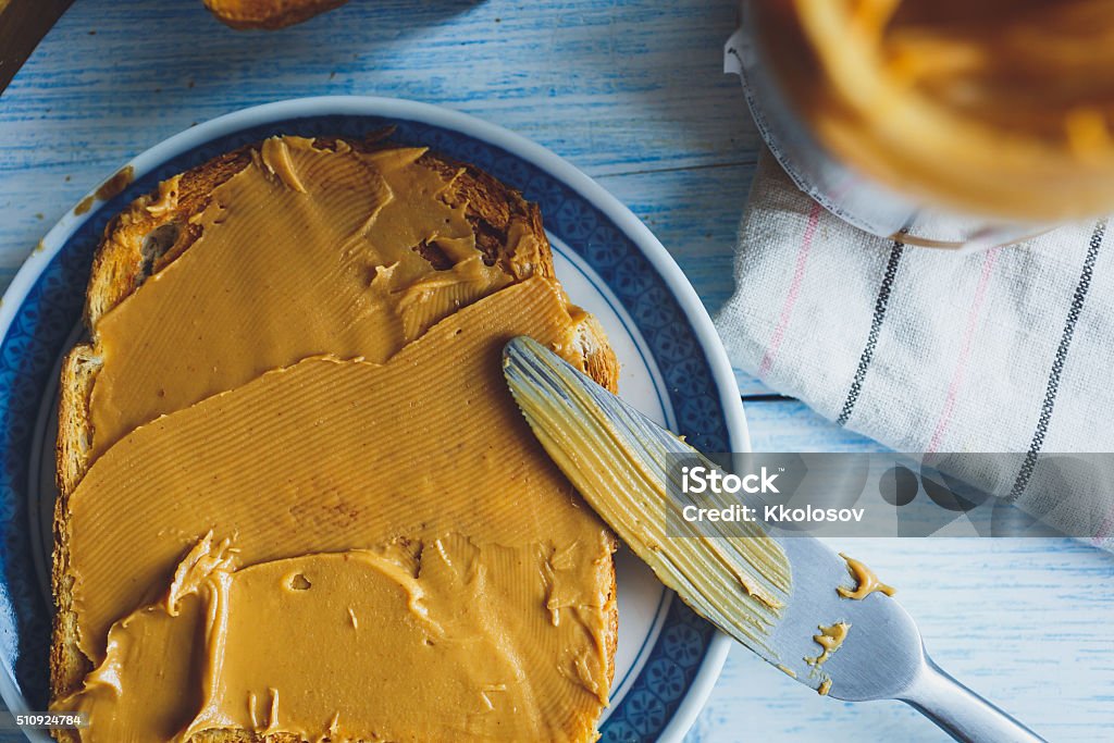Peanut butter sandwiches or toasts Peanut butter sandwiches or toasts  on light wooden background Butter Stock Photo