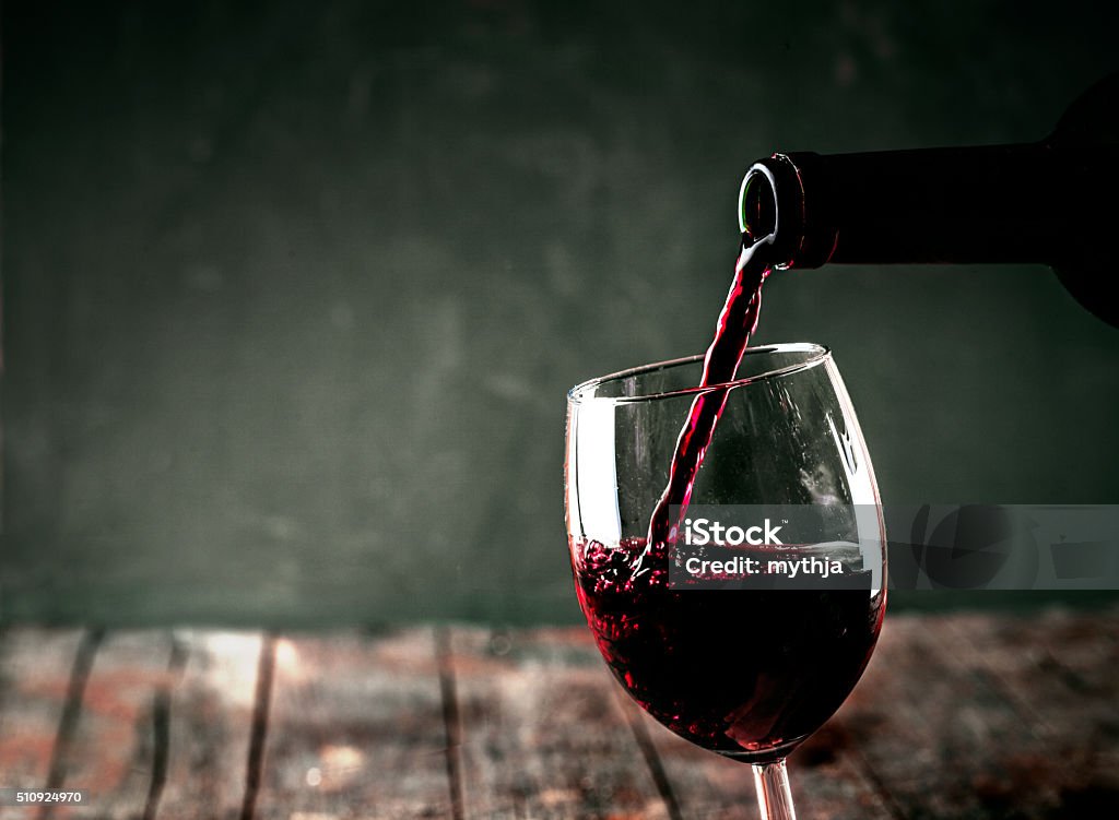 Red wine Red wine. Glass of wine. Pouring red wine. Drinking Glass Stock Photo