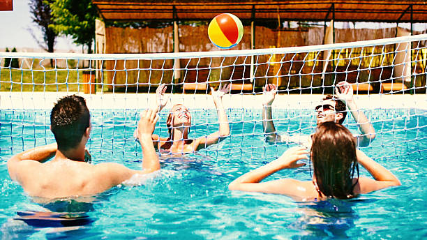 istock People playing volleybay in swimming pool and having beers. 510927732