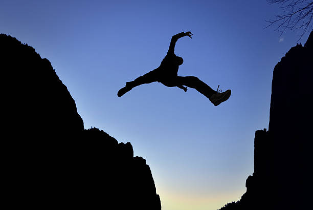 istock Man Jump through the Gap 510947692