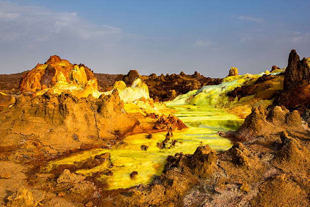 Landscape of Danakil depression, Ethiopia Danakil depression landscape with red formations and sour river.  Sulfur, salt and other minerals paint water in fantastic colors. danakil depression stock pictures, royalty-free photos & images