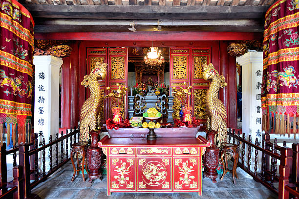 Hong Kong, China - December 31, 2018: A man lighting some  incenses at Taoist Temple in Hong Kong, China, Asia.