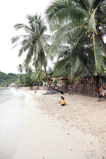 El Nido, Palawan, Philippines - February 17, 2012: Residents of El Nido spend time on the beach in the city center