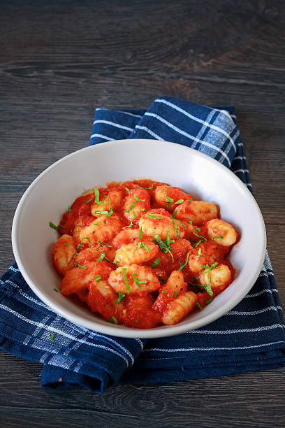 Homemade italian gnocchi with tomato sauce on a table